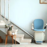 Modern straight residential stairlift installed along a staircase in a bright home for safe and independent indoor mobility.